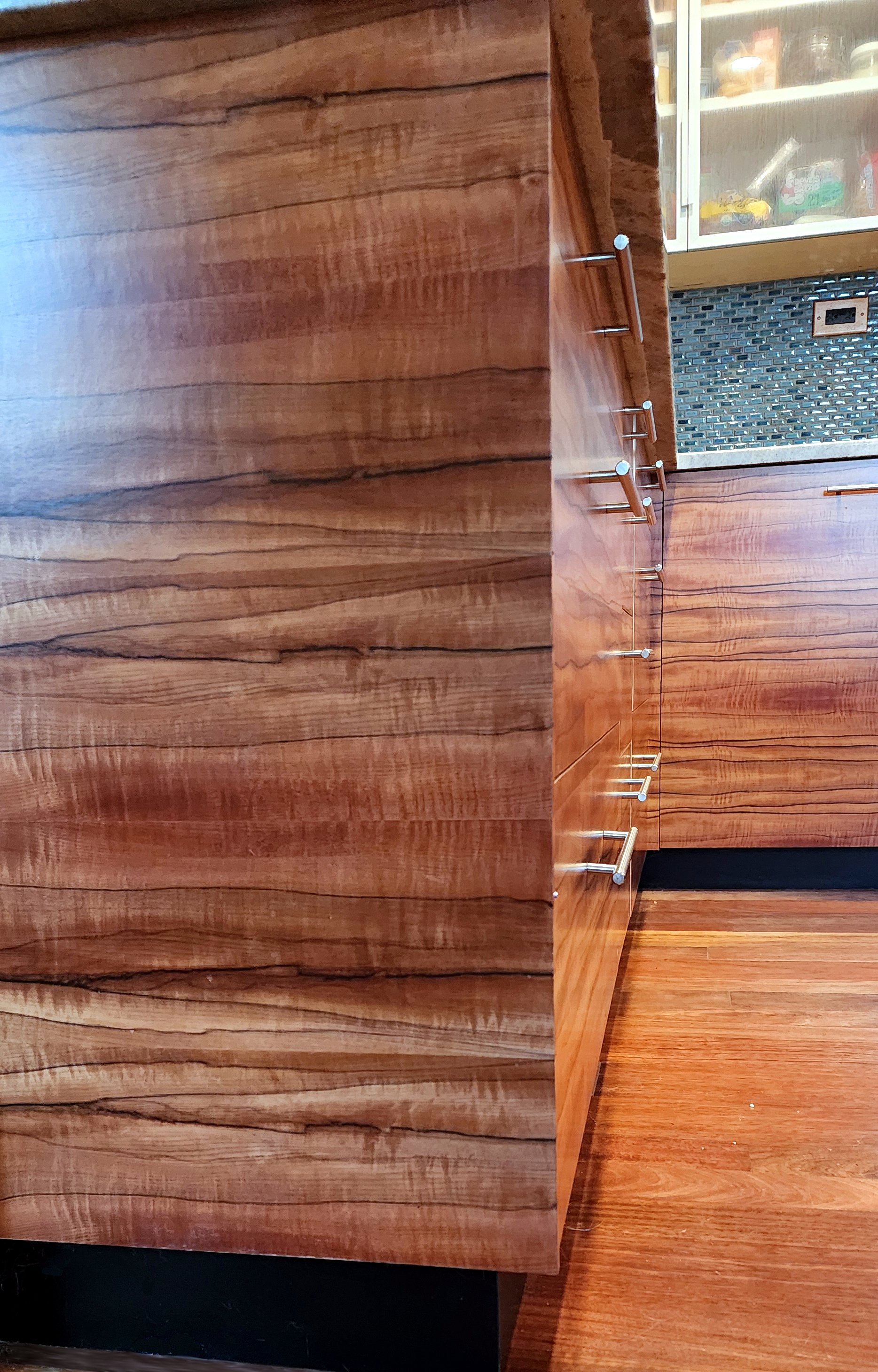 Close-up of figured koa wood grain on cabinet doors