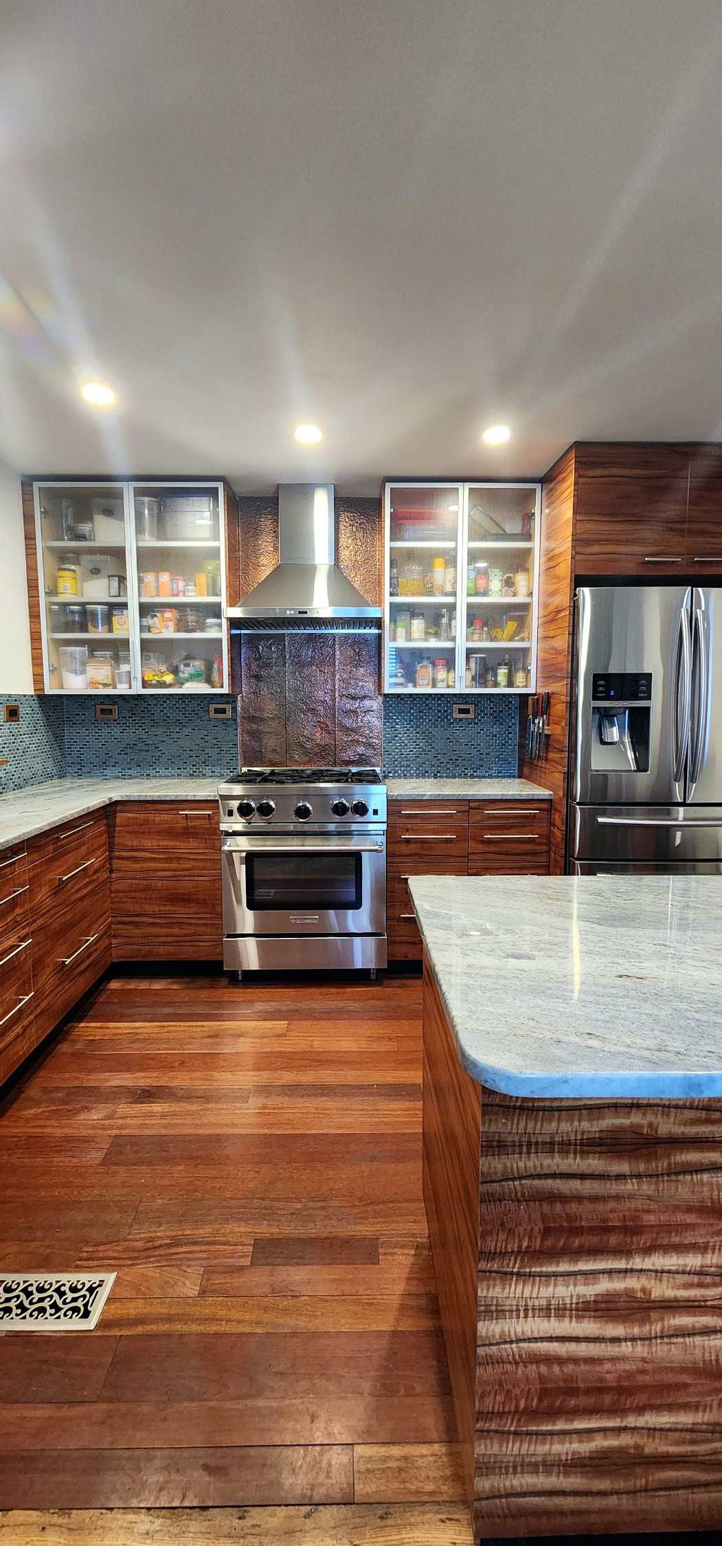 Custom kitchen cabinetry perspective showing island and full layout
